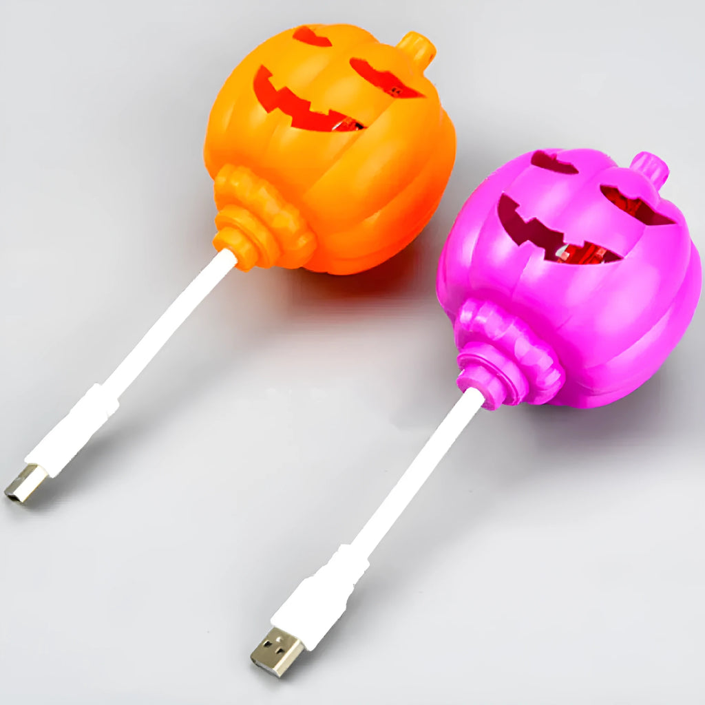 Plastic pumpkin-shaped decorative lamp with a USB cable, glowing either yellow or purple.