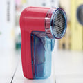Portable electric lint remover device for removing pills from clothing and sweaters