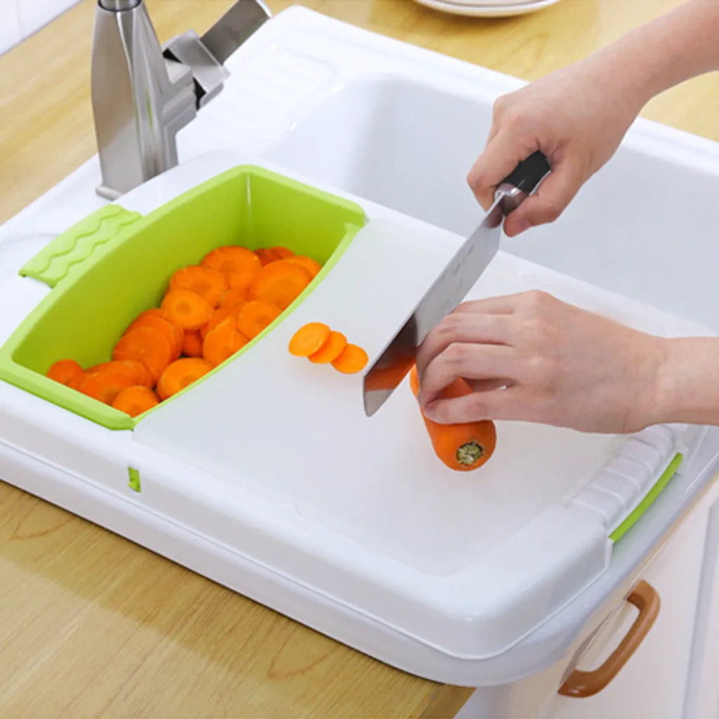 Green multifunction cutting board with drainage holes mounted on a kitchen sink edge.