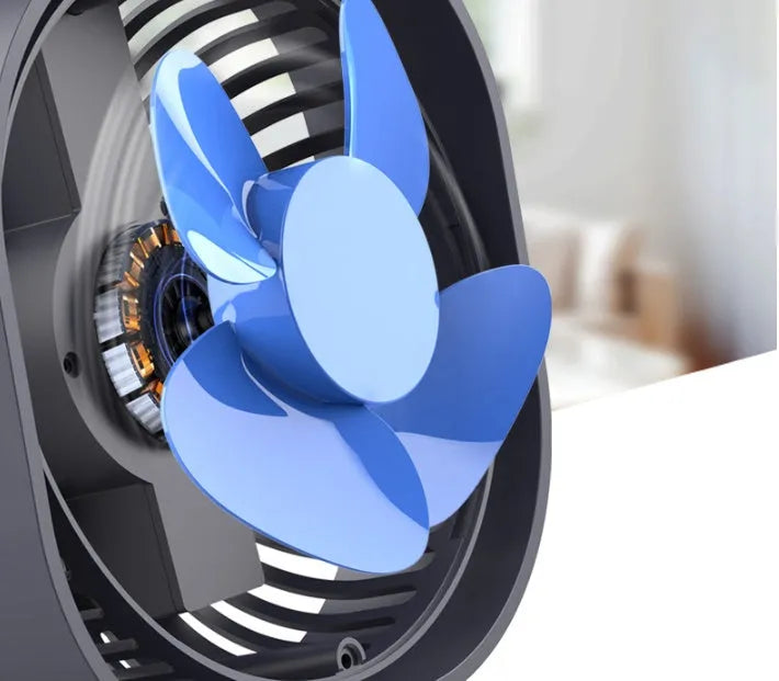 Pink USB desk fan with 360-degree rotating head on a white desk.