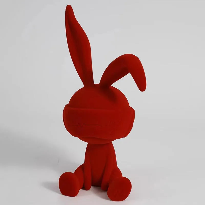 Resin rabbit table ornament with a suede blindfold in green, blue, or red colour options.