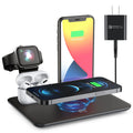 Black multi-device wireless charging station for phone, smartwatch, and headphones on a wooden desk.