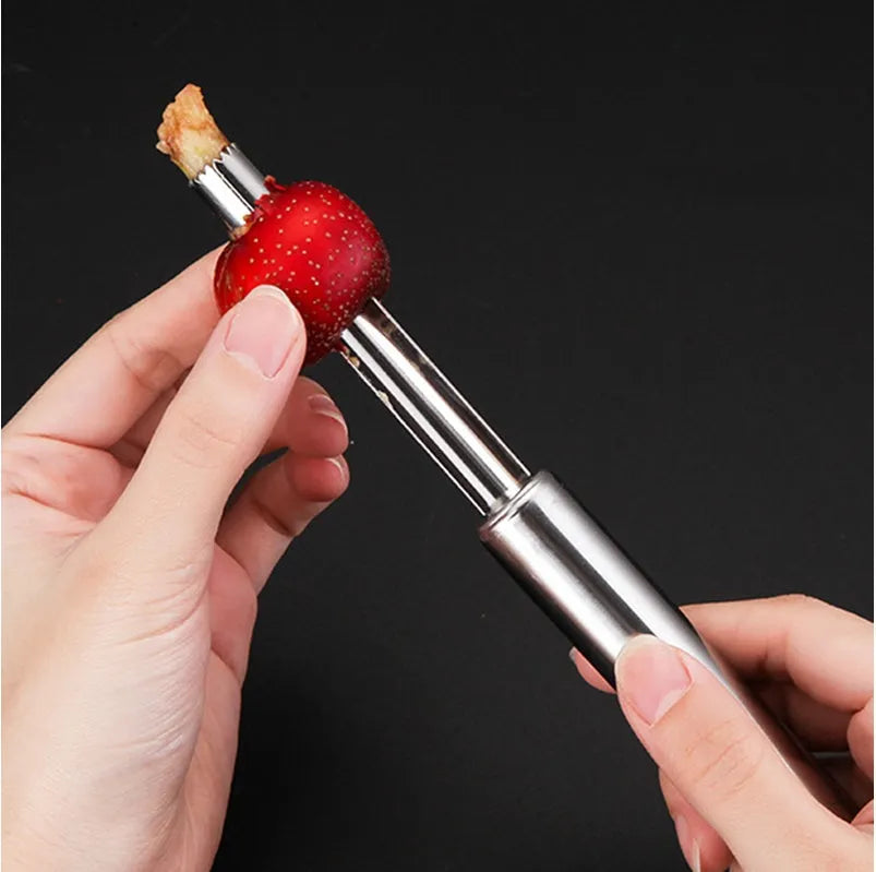 Stainless steel pineapple corer slicer with ABS handle showing pineapple preparation