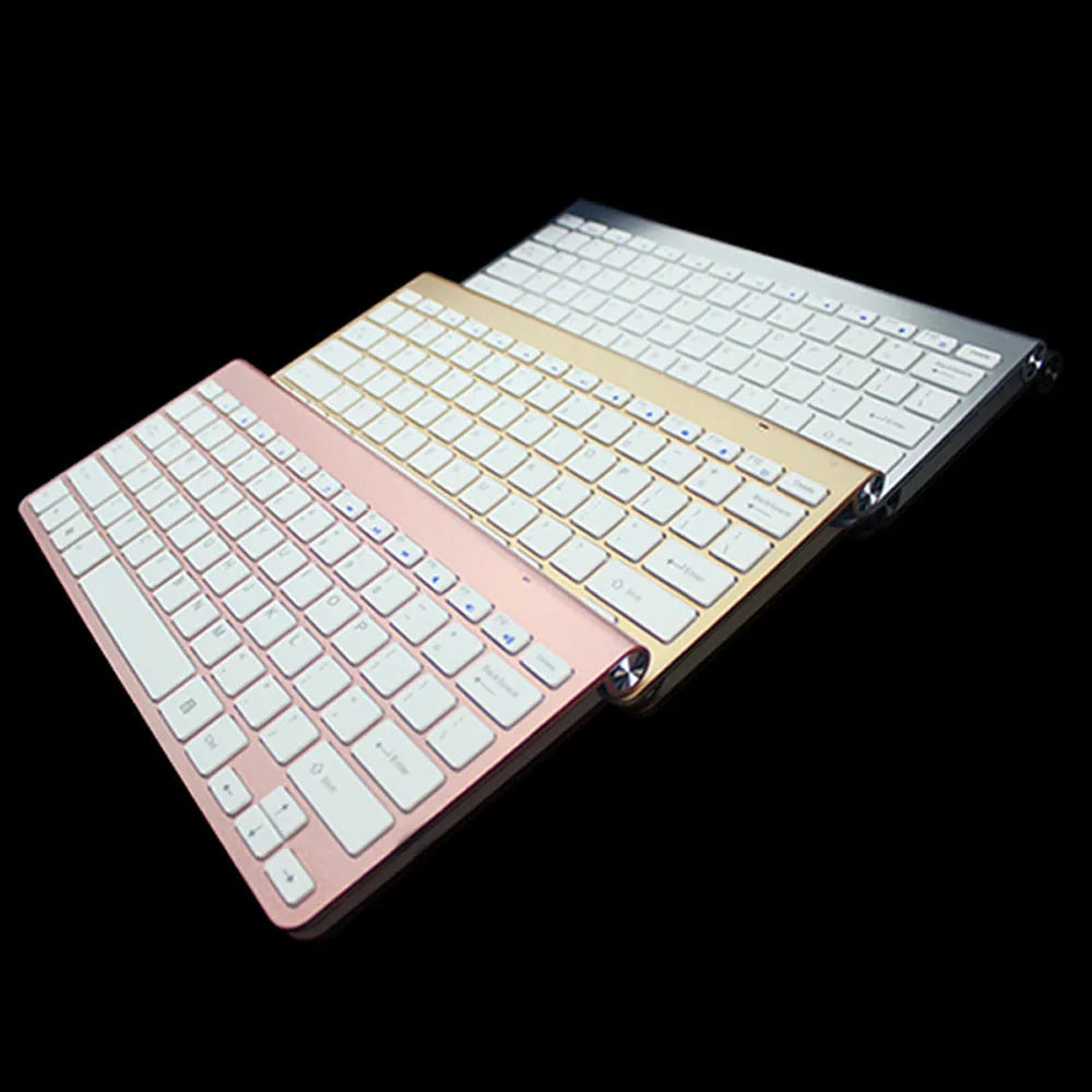 2.4G wireless keyboard and mouse combo set in silver colour on a desk with laptop