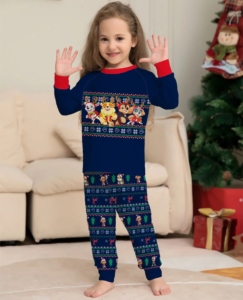 Matching red and black plaid Christmas pyjamas with deer print for men, women, children, and a dog