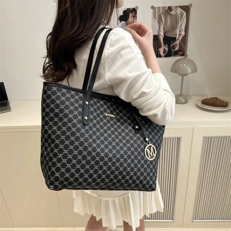 Black PU shoulder bag with sewing thread detail, showing interior polyester lining.