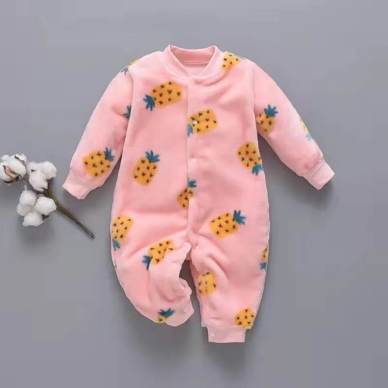 Baby wearing a long sleeve flannel romper in a panda or dinosaur print.