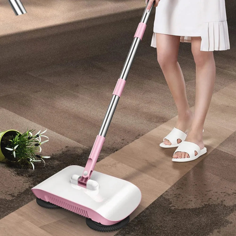 Pink hand push sweeper with rotating brush on floor shows broom dustpan mop all-in-one design