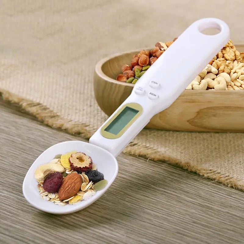 White digital spoon kitchen scale with LCD display showing weight measurement