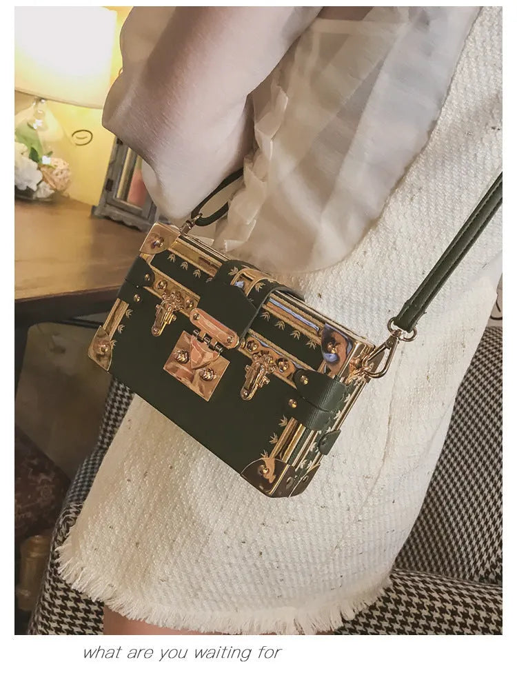 Black structured women's shoulder bag with flap and single strap.