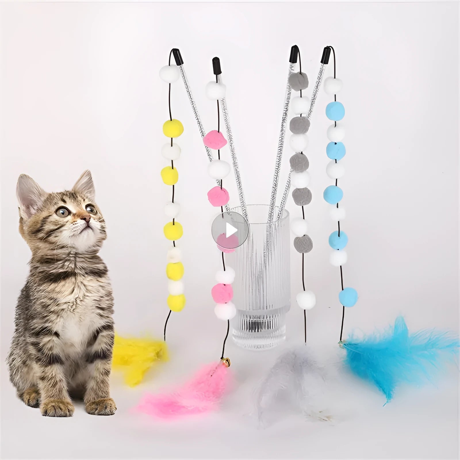 A 31cm long cat teaser toy stick with a colourful pompon, feathers, and a bell.