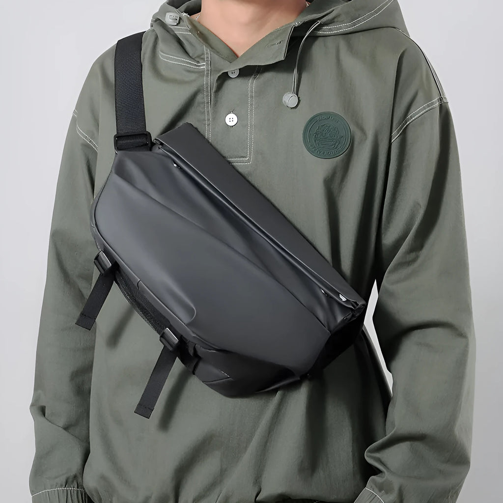 Grey men's crossbody sling bag made of PU leather with a zip opening and shoulder strap.