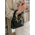 Champagne-gold PU shell bag with stitched seams, worn as a shoulder bag against a neutral background