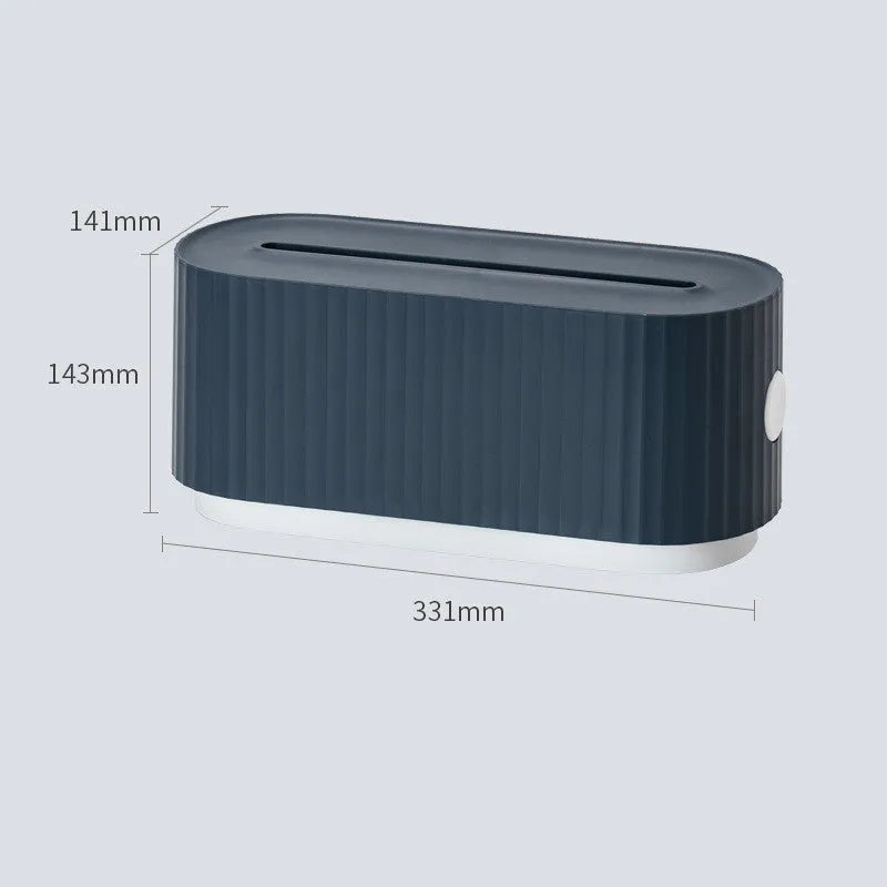 Blue and white plastic cable management box for power strips with lid open showing phone slot and cable holes