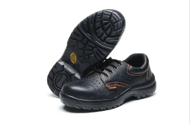 Black antiskid safety work shoes with steel toe, embossed cowhide upper, on a white background