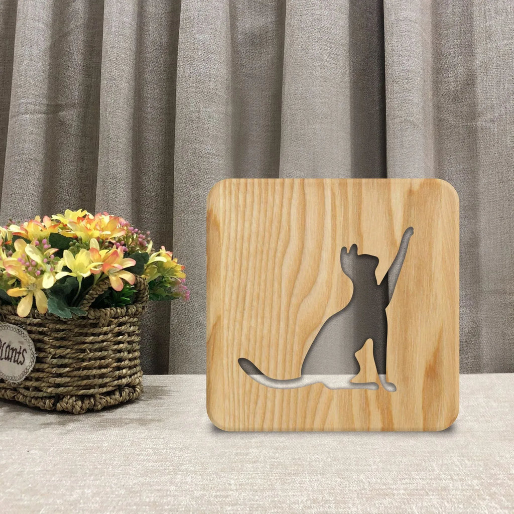 Solid wood cat-shaped night light with 3D hollow design and USB cable.