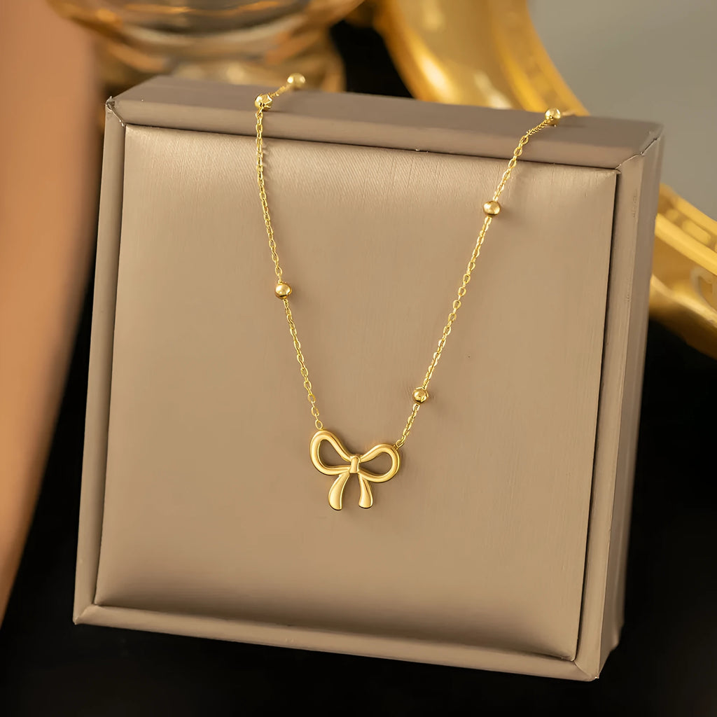 Gold titanium steel bow necklace for women with adjustable length and cross chain design