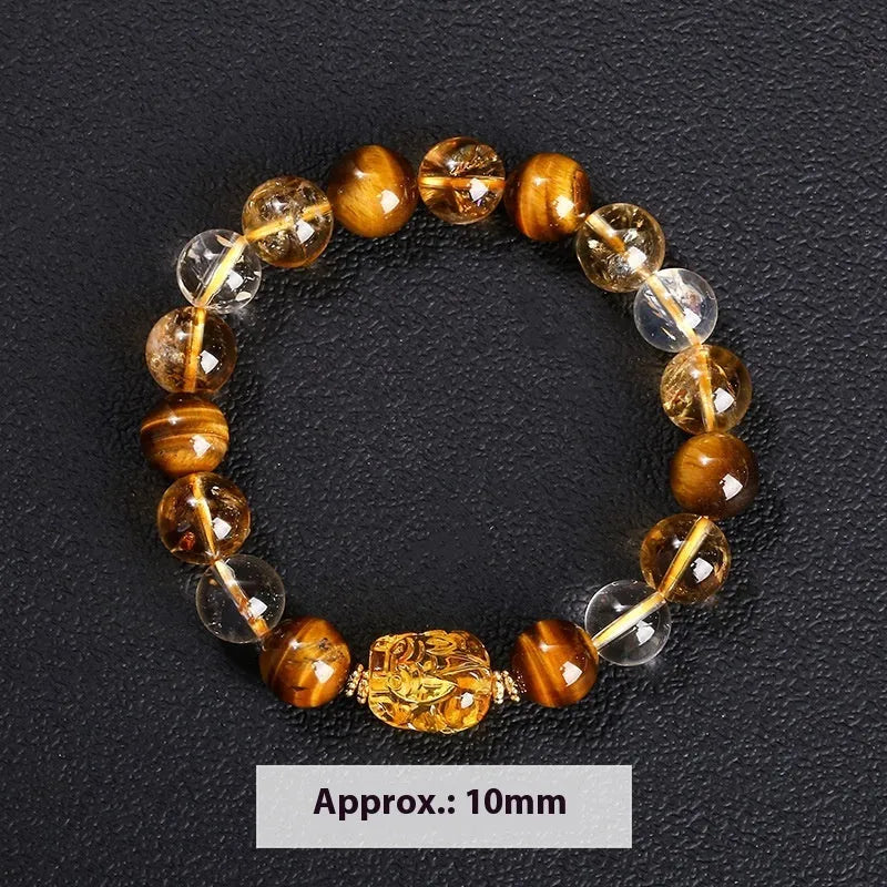 Close-up of a unisex bracelet with 10mm yellow tiger's eye and citrine round beads and a detailed beeswax pi xiu charm.