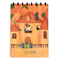 Children's A4 drawing book with PP cover, 15 pages, in orange colour, laid open on a desk