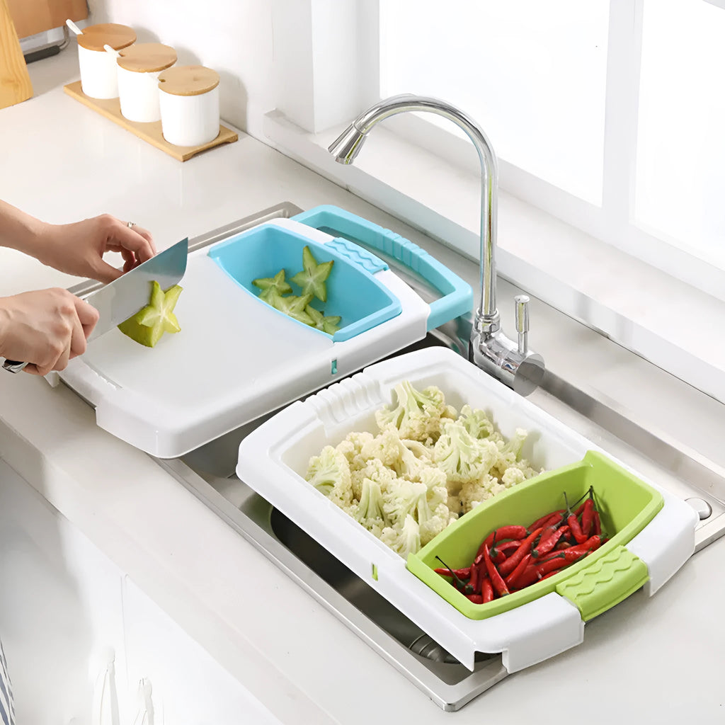 Green multifunction cutting board with drainage holes mounted on a kitchen sink edge.