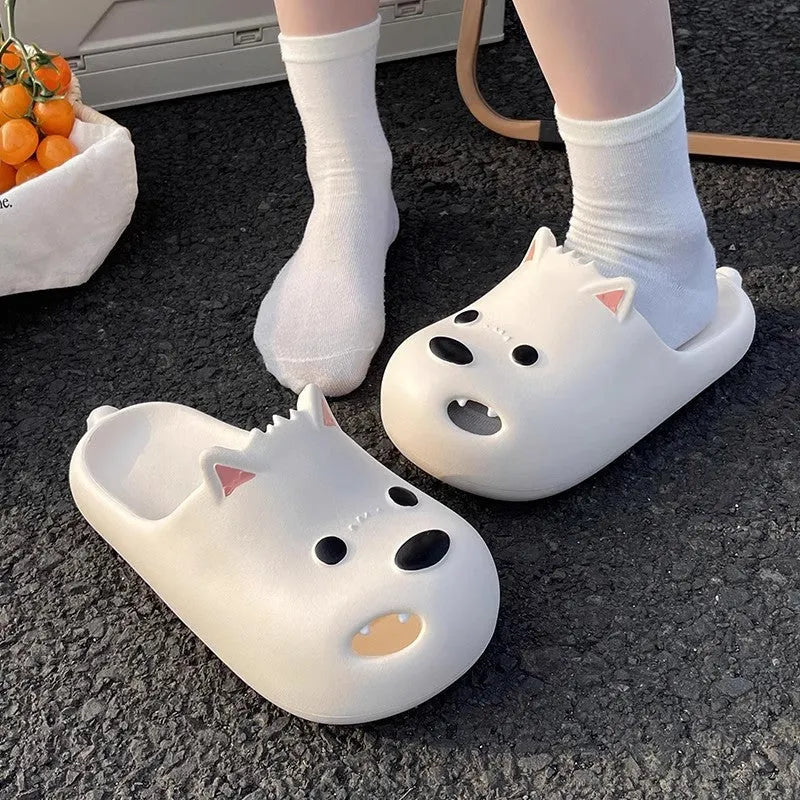 Women's black and white EVA puppy slippers with a toe-cap sandal design on a plain background.