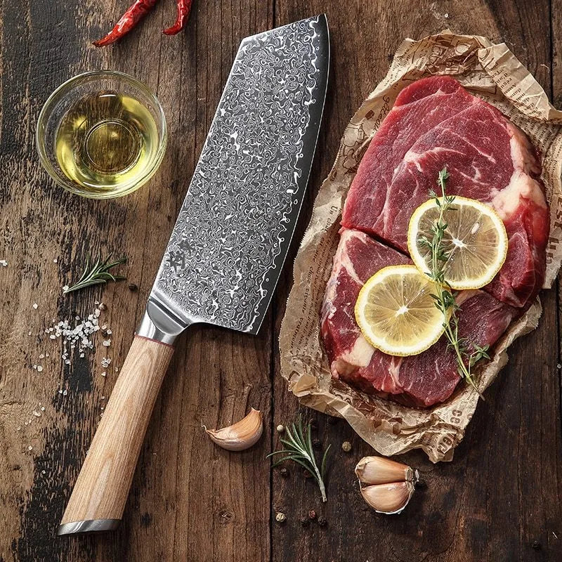 V gold Damascus kitchen knife set with 67-layer steel construction showing distinctive patterning on multiple blade sizes