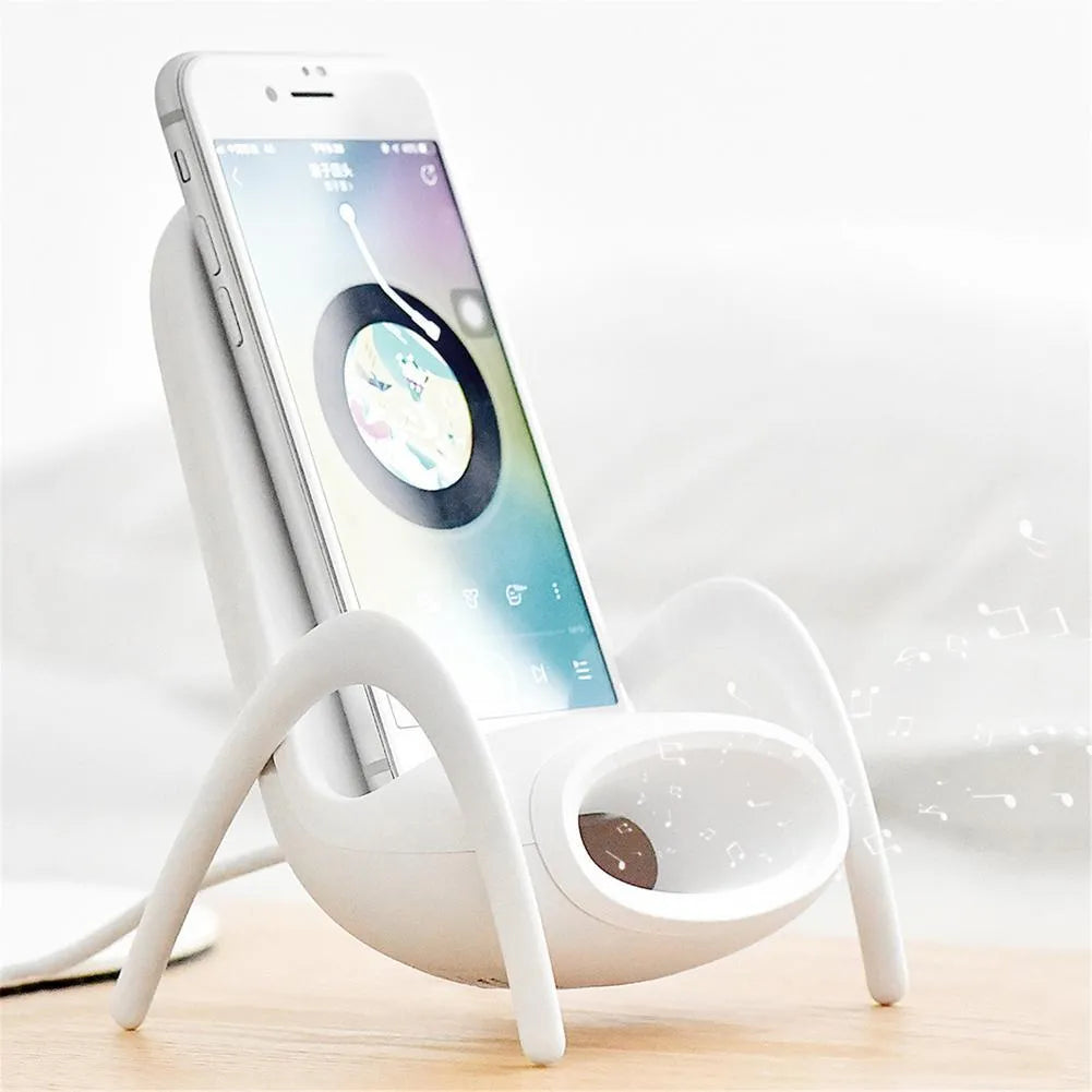 White mini chair-shaped wireless phone charger and holder on a desk