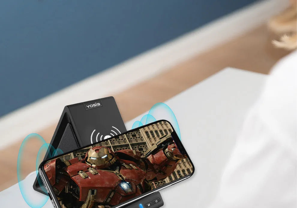 Black multifunctional Bluetooth speaker with integrated wireless charging power bank and mobile phone stand.