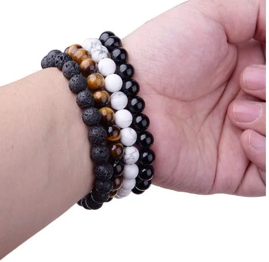 Black agate geometric bracelet with 8mm beads on a black elastic cord.