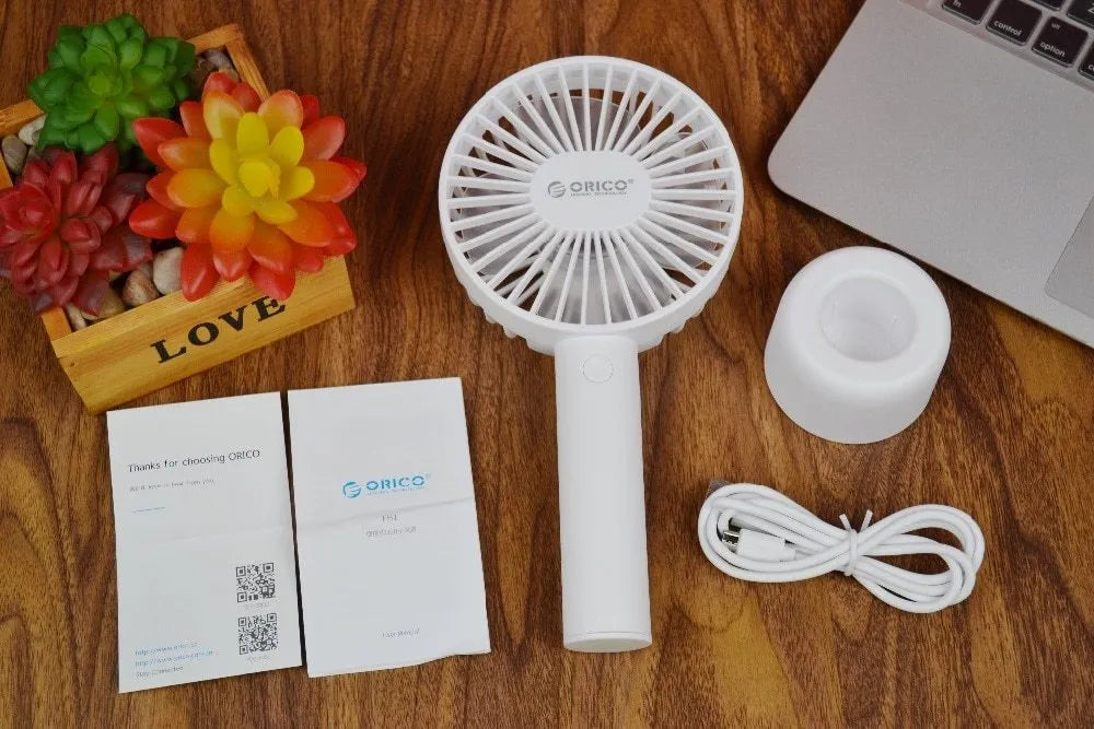 White ORICO FH1 portable USB rechargeable desk and handheld fan on a table
