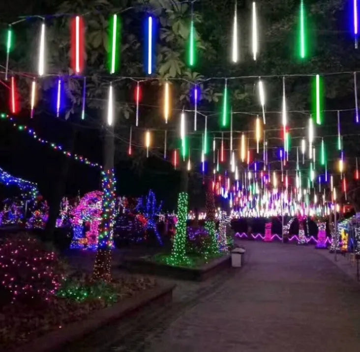 Waterproof LED meteor shower light set with 8 tubes in outdoor garden installation.