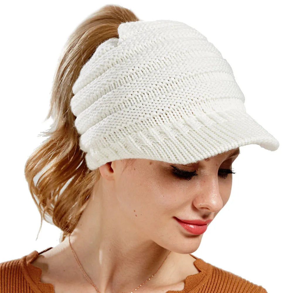 Women's knitted acrylic beanie hat designed for wearing with a ponytail or bun.