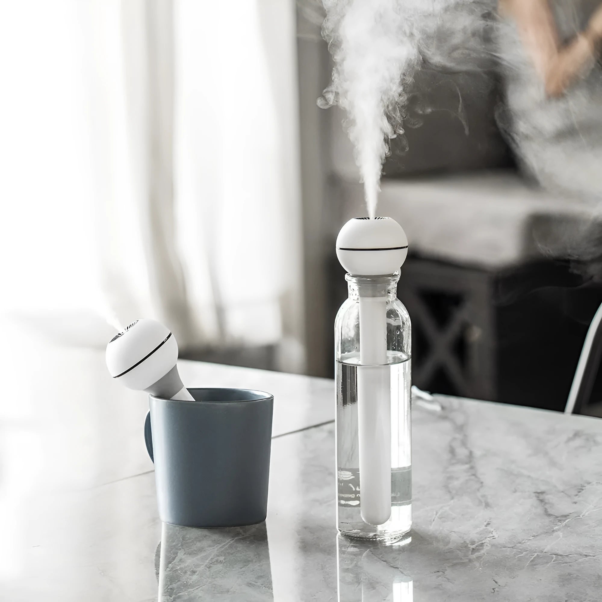 Columnar pink and white magic wand ultrasonic humidifier with 1 litre tank for desktop use.