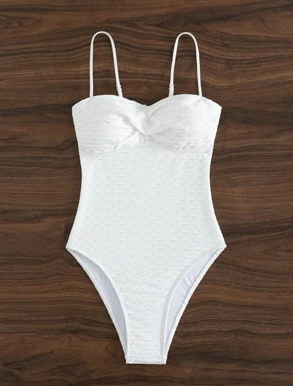 White one-piece women's swimsuit with sling straps and brief styling on mannequin