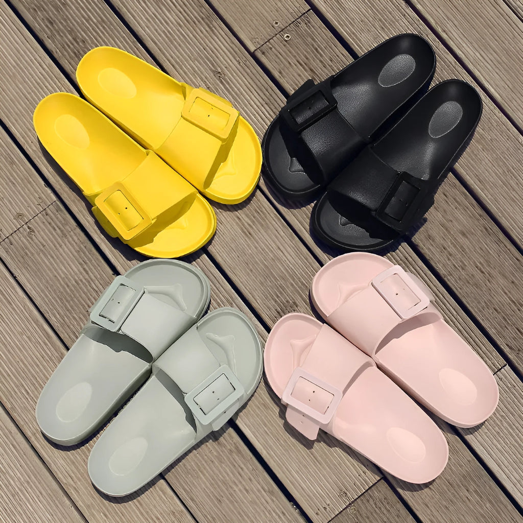 Women's grey blue EVA slippers with a buckle strap and soft sole on a white background