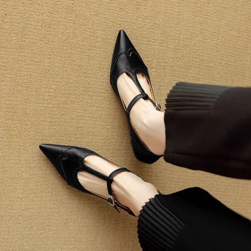 Women's black high heel pump with vintage skull engraving and stiletto heel.