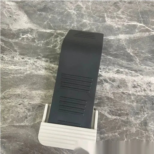 Gray rubber arch-shaped door stopper with a non-slip base on a light floor surface