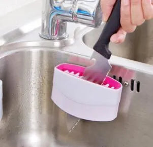 Kitchen cleaning brush with suction cup base and cutlery grooves in blue, green or pink