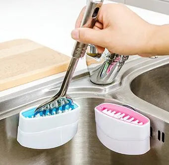 Kitchen cleaning brush with suction cup base and cutlery grooves in blue, green or pink