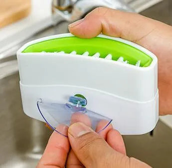 Kitchen cleaning brush with suction cup base and cutlery grooves in blue, green or pink