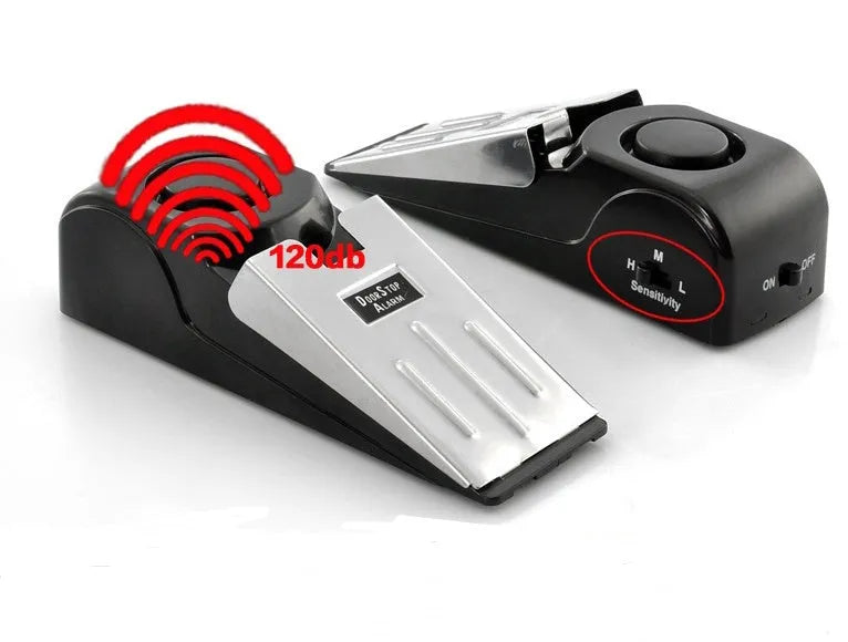 Black portable door stop alarm with wedge shape and stainless steel sensor cover.