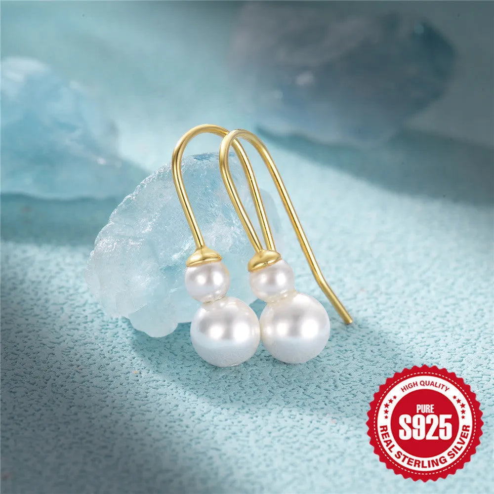 Close-up of sterling silver sunflower earrings with golden zirconia stones on a white background.
