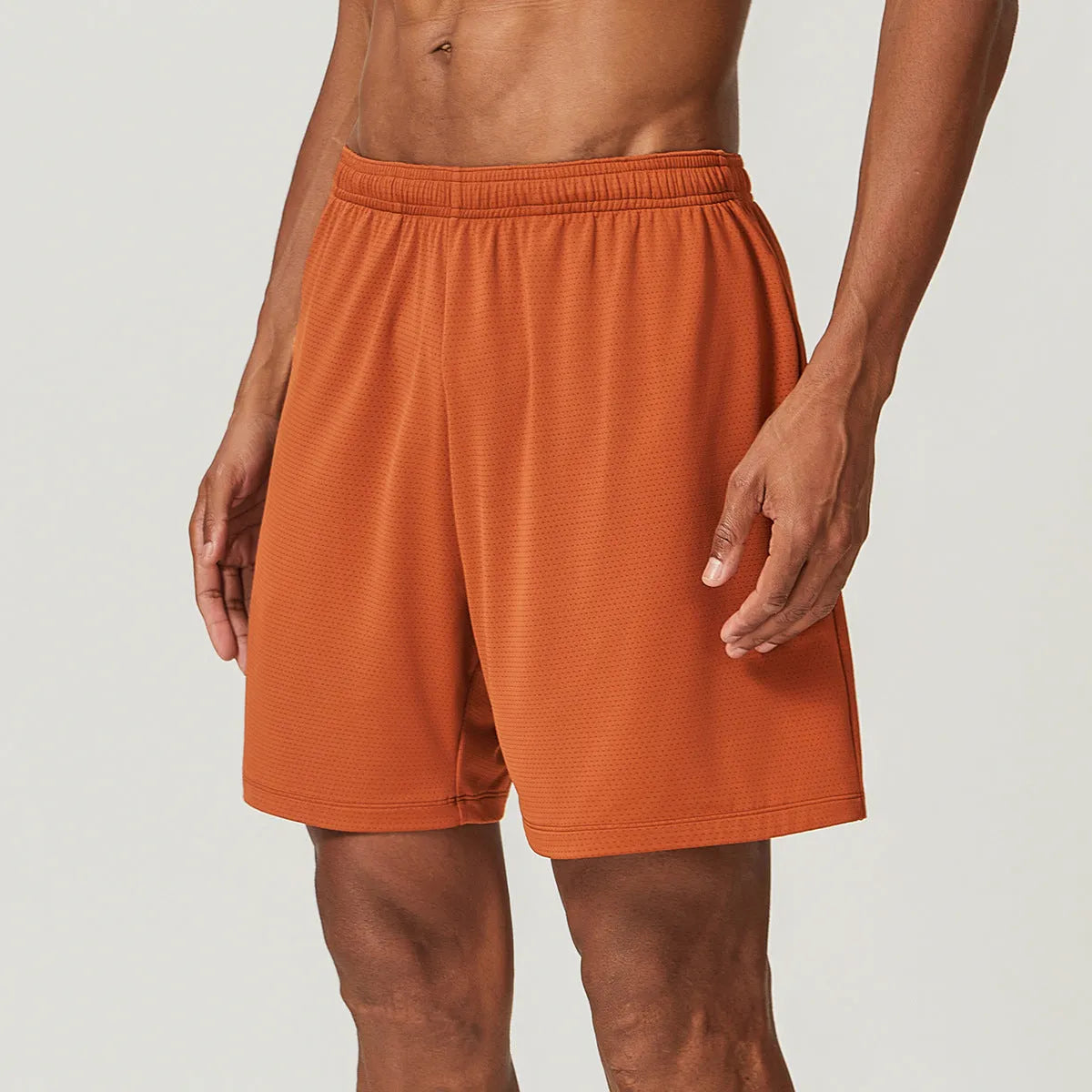 Man wearing sky green quick-drying double-layer running shorts for exercise.