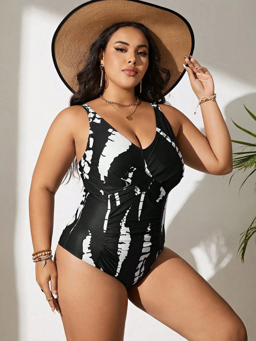 Black Siamese colour matching one-piece swimsuit on a hanger, showing sleeveless design.