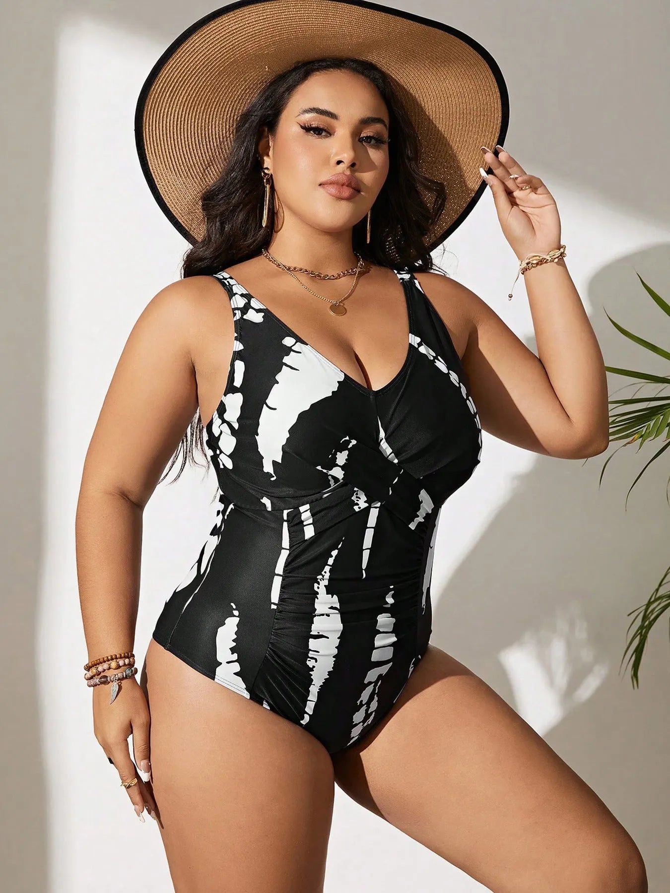 Black Siamese colour matching one-piece swimsuit on a hanger, showing sleeveless design.