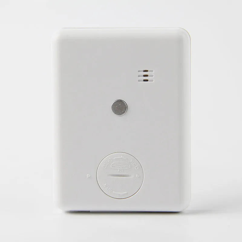 Black and white digital kitchen timer with LED display shown on a magnetic refrigerator door.