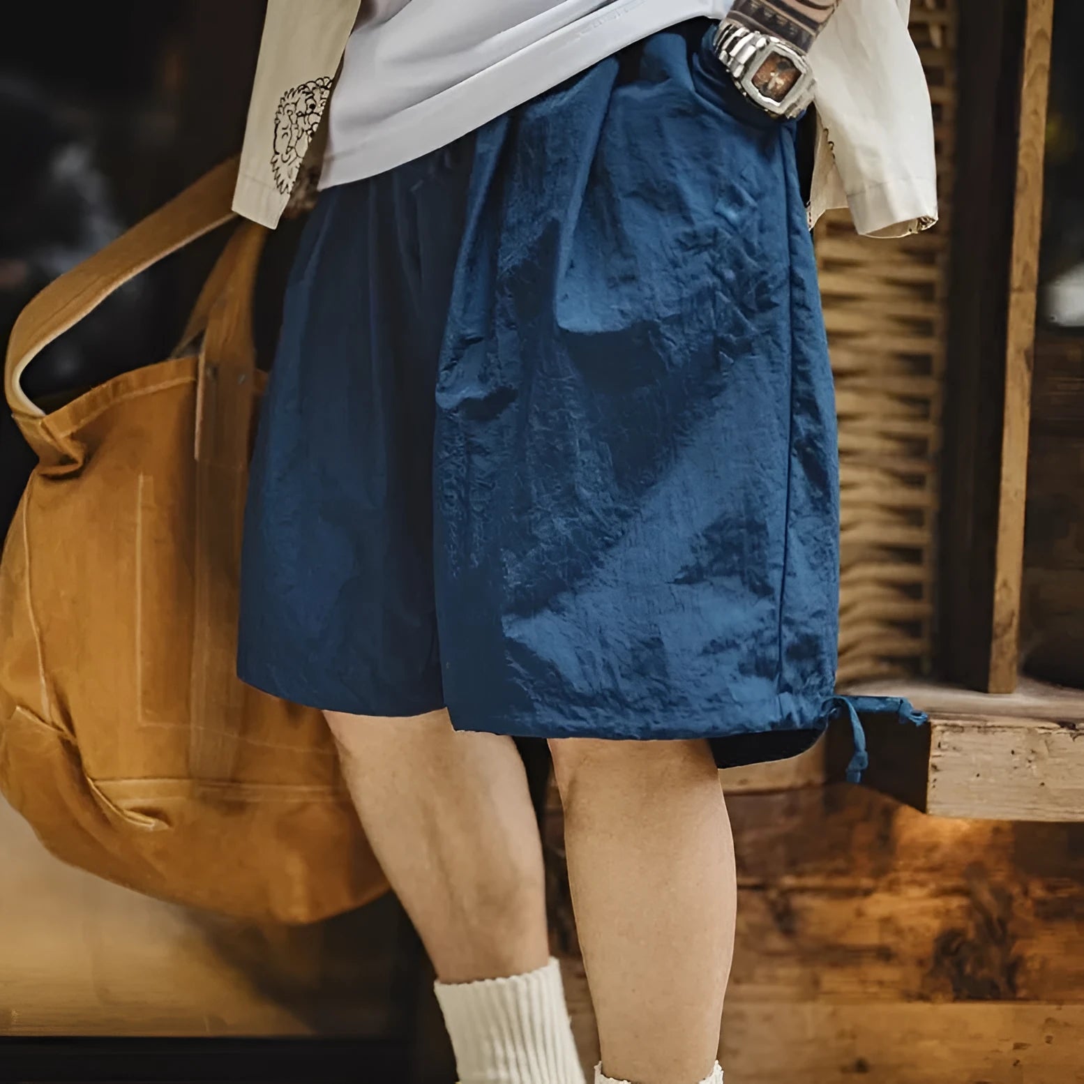 Men's loose fit nylon shorts in Prussian Blue with embroidered detailing