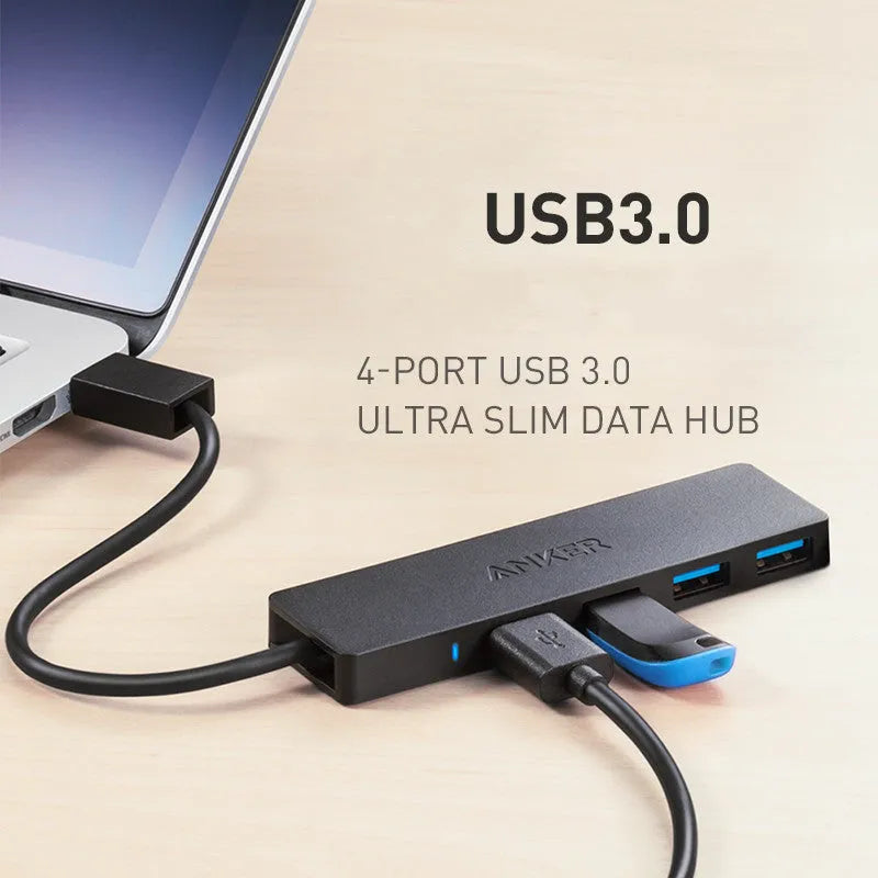 Black Anker 4-port USB 3.0 hub with short attached cable on a desk.