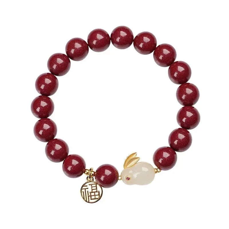 Purple gold sand cinnabar bracelet with a jade hare charm, shown in 6mm and 8mm bead sizes.