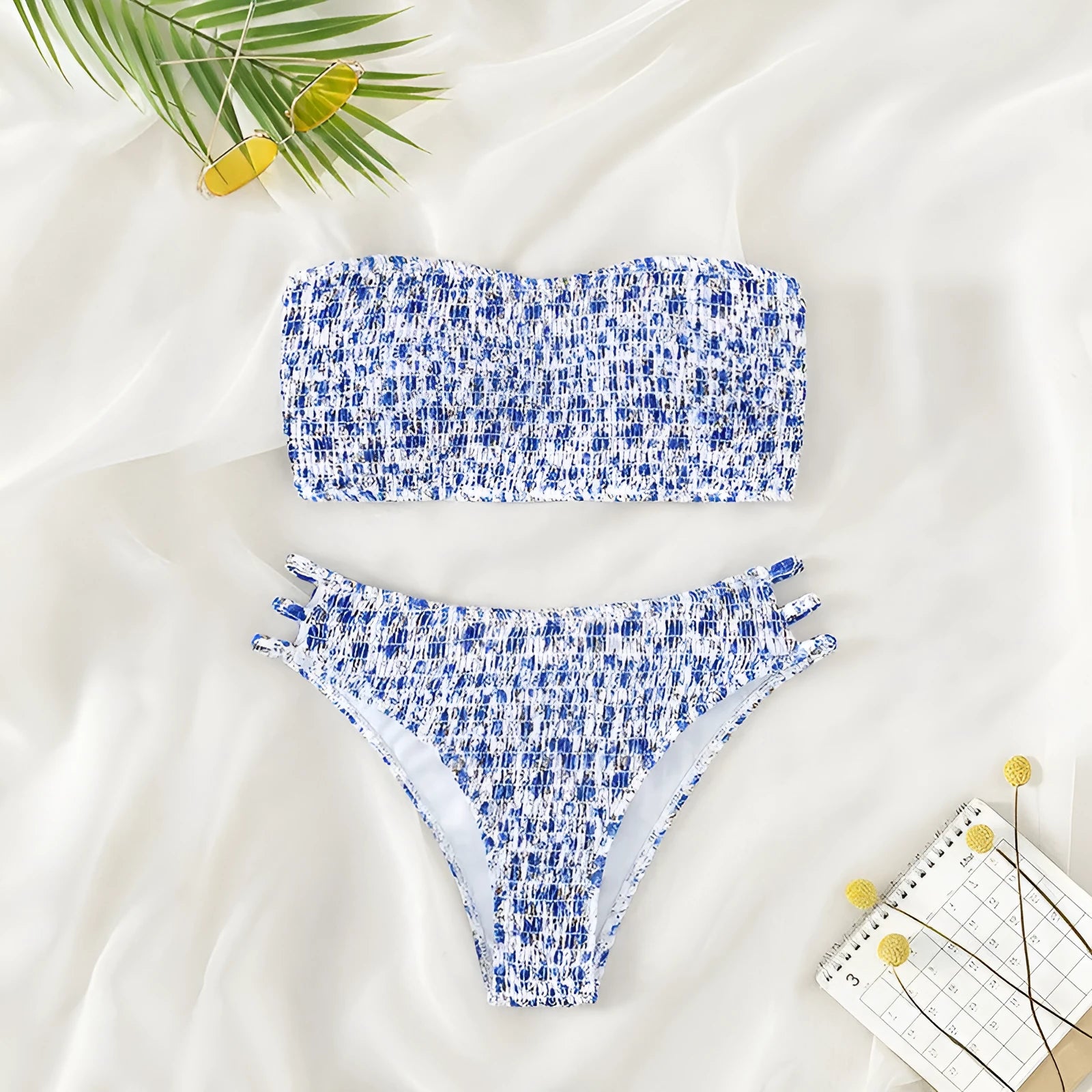 Women's floral strapless swimsuit with split back and high-waist briefs on white background.